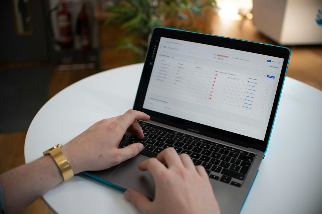 person calculating debts on laptop